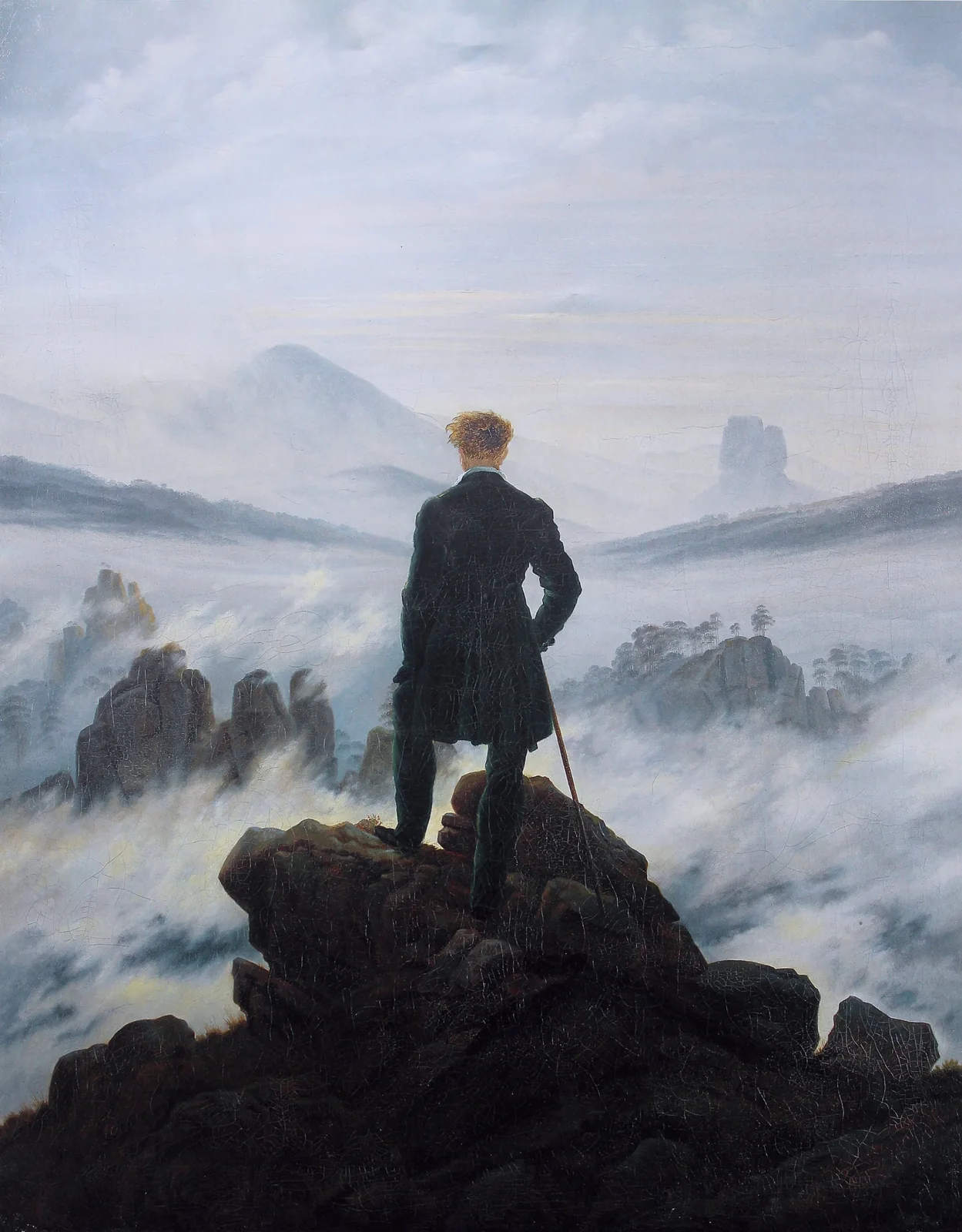 Caspar David Friedrich, Der Wanderer über dem Nebelmeer: eine Gestalt auf einem Felsen blickt über ein Meer aus Nebel und Bergrücken.